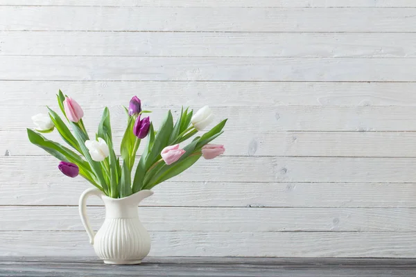 Spring flowers in white vase — Stock Photo, Image