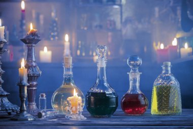 magic potions in bottles on wooden background  clipart