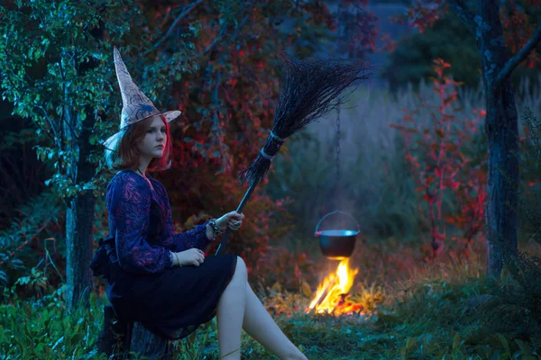 Young witch by  fire in night forest — Stock Photo, Image