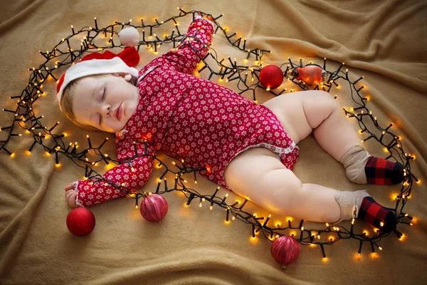 Sleeping baby with Christmas decorations — Stock Photo, Image