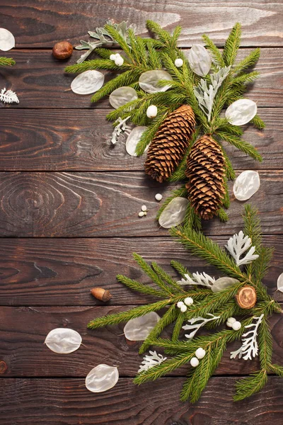 Christmas fir branches and decorations on dark wooden background — Stock Photo, Image