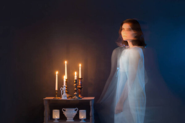 Ghost of young girl on blue background