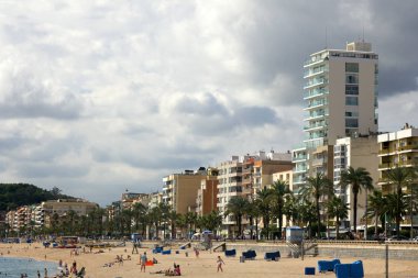 İspanya, Lloret de Mar - 2 Ekim 2017: Akdeniz'in düşük sezonunda palmiye ağaçları oteller ve tatilciler ile turistik plaj