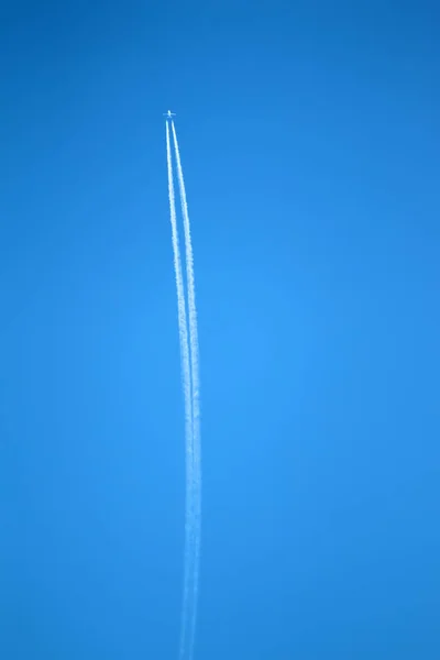 Quickly flying plane against dark blue sky.