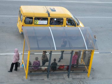 A 'marshrutka' routed taxi and bus stop with people clipart