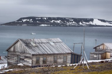 Severe land. One of the oldest polar stations in Arctic (founded in 1928, now abandoned). Wooden houses have been preserved well. Frantz Josef Land, island Hooker. Russian Arctic clipart