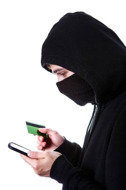 Hacker with a Phone and a Bank Card Isolated on the White Background clipart