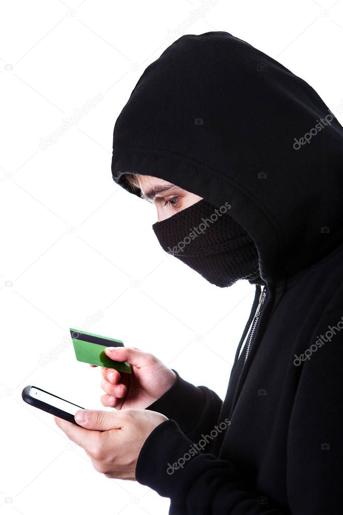 Hacker with a Phone and a Bank Card Isolated on the White Background