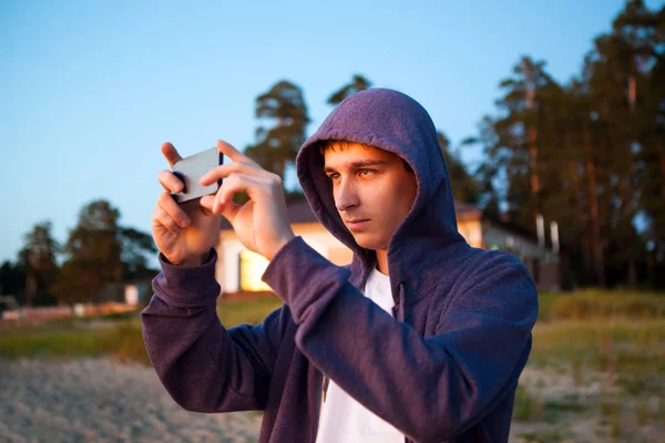 Молодой Человек Делает Фото Телефоном Фоне Природы — стоковое фото