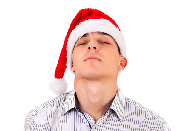 在白色背景查出的圣诞老人帽子疲惫的年轻人 — 图库照片