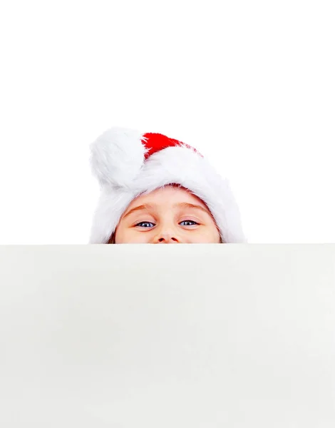 Κοριτσάκι Καπέλο Santa Πίσω Από Έναν Κενό Πίνακα Για Λευκό — Φωτογραφία Αρχείου