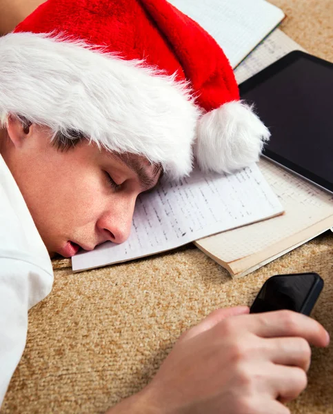 Κουρασμένος Νεαρός Καπέλο Santa Ύπνο Στα Βιβλία Ένα Closeup Του — Φωτογραφία Αρχείου