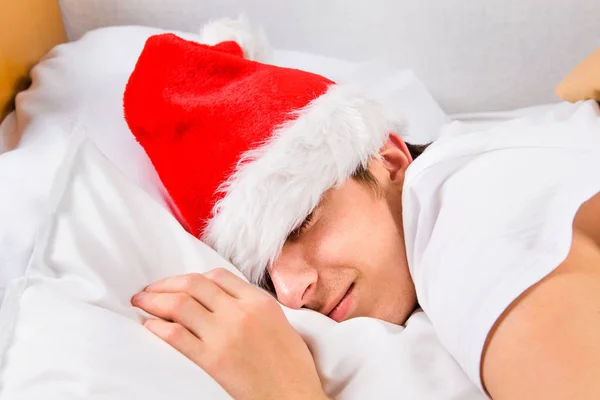 Young Man Santa Hat Sleep Bed Home — Stock Photo, Image