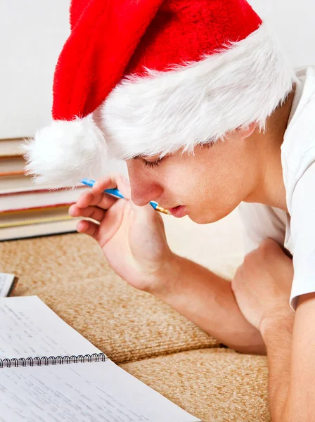 Student Santa Hat Doing Homework Sofa — Stock Photo, Image