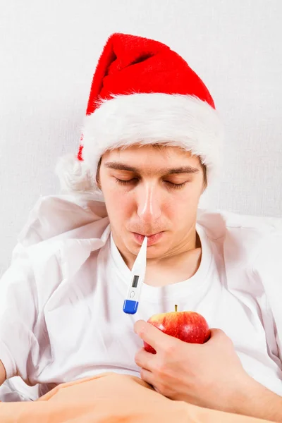 Sick Young Man Santa Hat Thermometer Bed — Stock Photo, Image