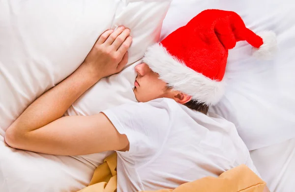 Tired Young Man Santa Hat Sleep Bed Home — Stock Photo, Image