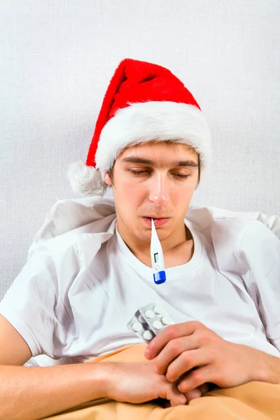 Sick Young Man Santa Hat Thermometer Bed — Stock Photo, Image