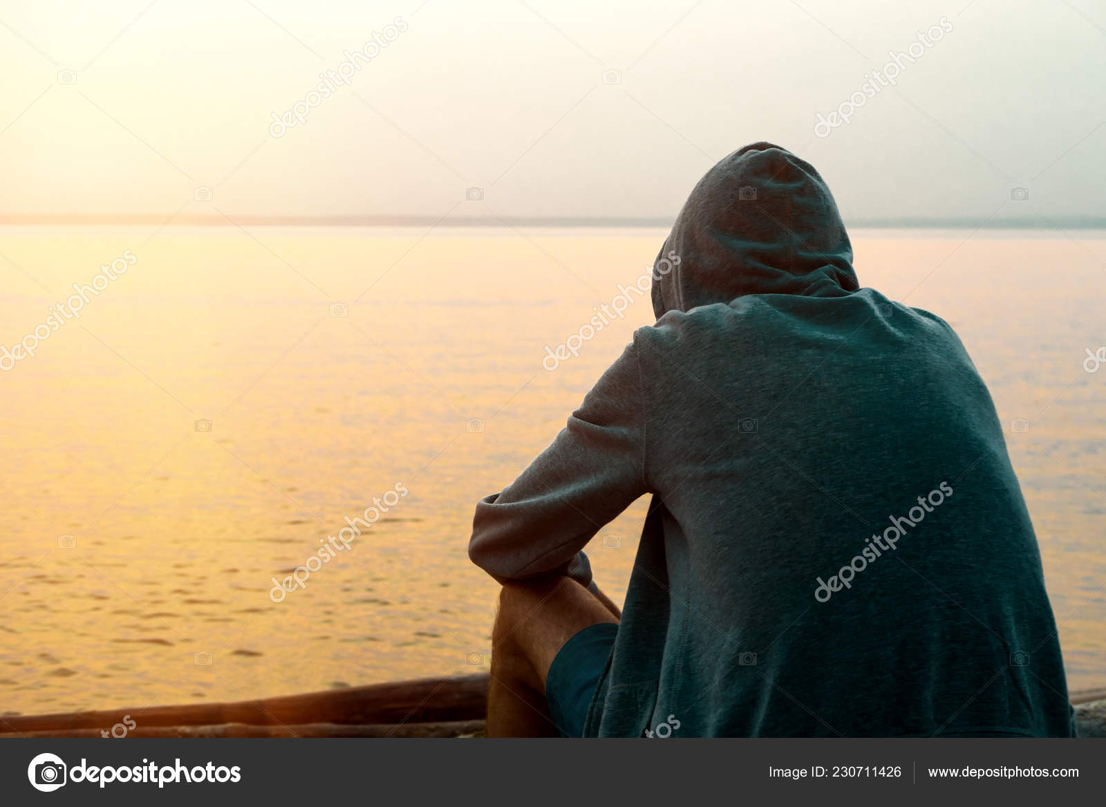 Toned Photo Lonely Young Man Hoodie Sit Sea Background — Stock