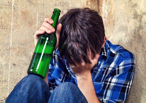 Sad Teenager in Alcohol Addiction with a Beer