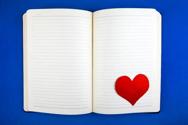 Blank Writing Pad Red Heart Shape Blue Paper Background Close — стоковое фото