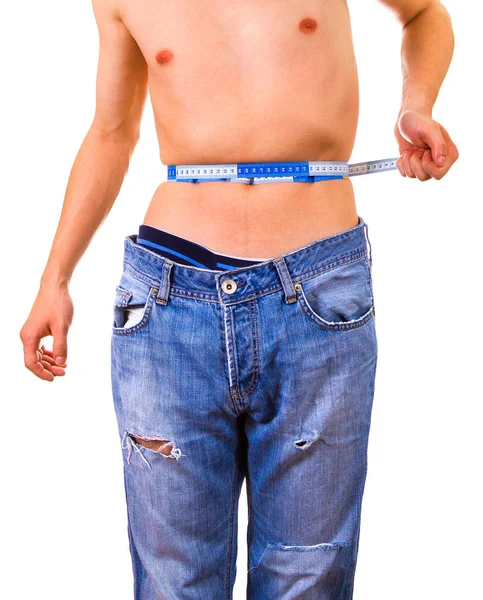 瘦男人在白色的背景上测量他的腰部 — 图库照片