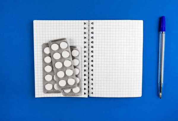 Writing Pad Pills Blue Paper Closeup — Stock Photo, Image