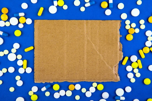 Pillen Und Leere Alte Pappe Auf Blauem Papier — Stockfoto