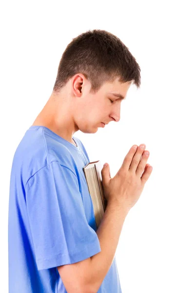 Молодой Человек Молится Библией Белом Фоне — стоковое фото