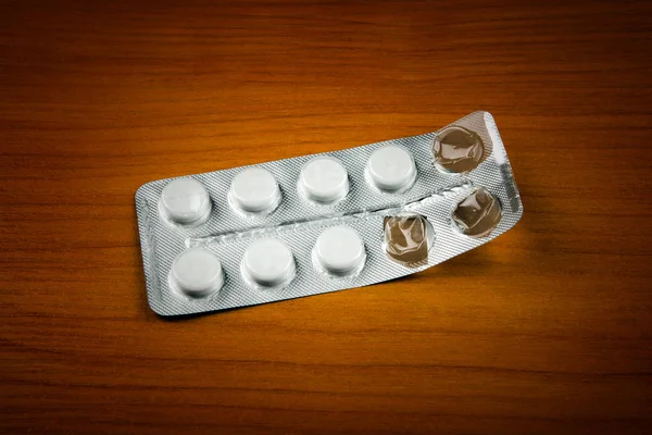 Vignetting Photo of the Pills Pack on the Table closeup