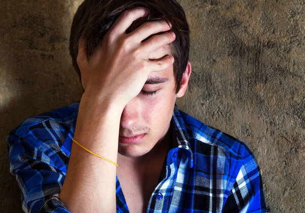 Sad Young Man Portrait by the Old Wall Closeup