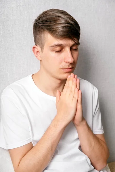 Young Man Praying White Wall Closeup — Stock Photo, Image