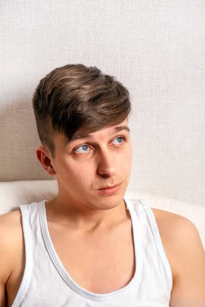 Pensive Young Man at the Home by the Wall