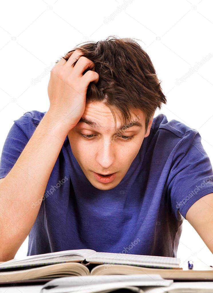 Tired and Troubled Student at the Writing Table on the White Background