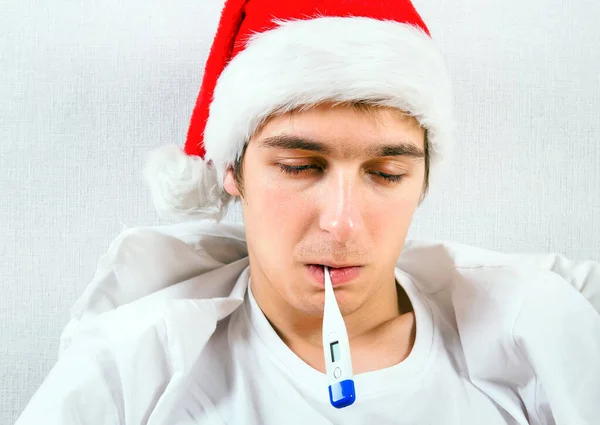 Sick Man Santa Hat Thermometer Bed Closeup — Stock Photo, Image