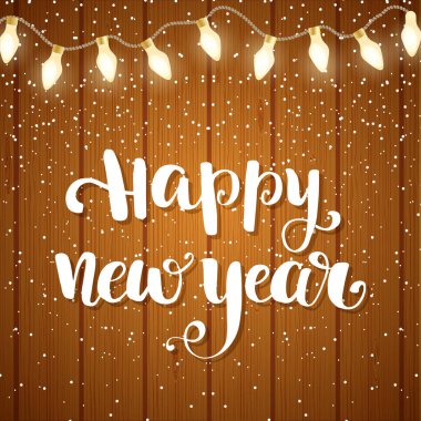 Kar taneleri ve metin mutlu yeni yıl yazı ile ışıkları ile ahşap plakalar arka plan