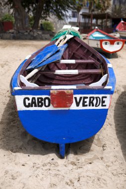 Old fishing boat on the shore. Boat with nets waiting for fishermen on the beach of Cape Verde clipart