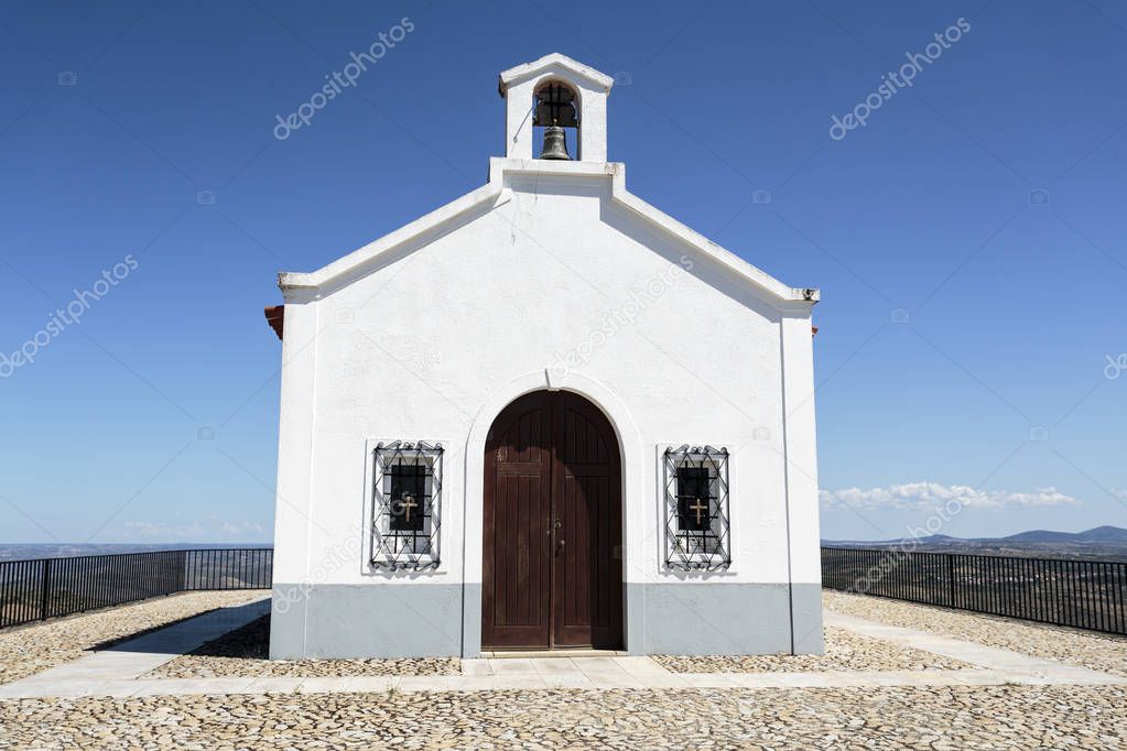 View of the nineteenth century Chapel of St Gabriel with a gable truncated by the bell tower, portal in perfect arch and two rectangular crevices, near the historic village of Castelo Melhor, Portugal