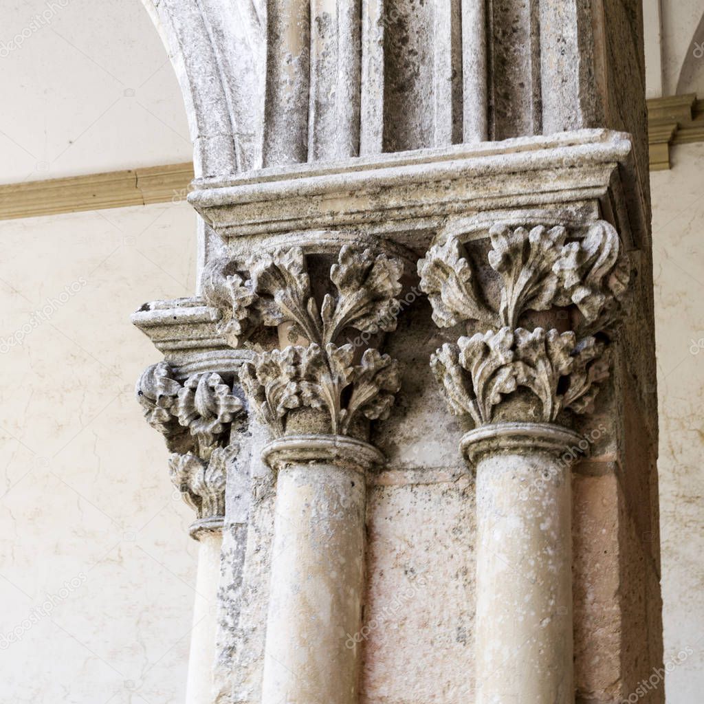 Detail of the Romanesque capitals depicting vegetal motifs on top of the columns in the Cemetery Cloister, in Tomar, Portugal 