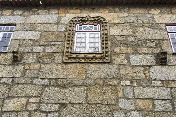 Manueline style window in the narrow streets of the medieval village of Linhares da Beira, Gouveia, Portugal