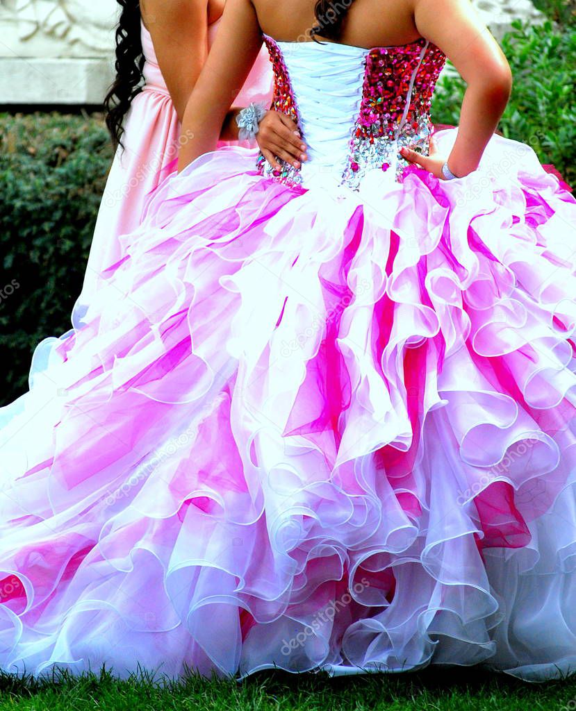 Quinceanera girls in formal gowns coming out celebration into womanhood at age sixteen.