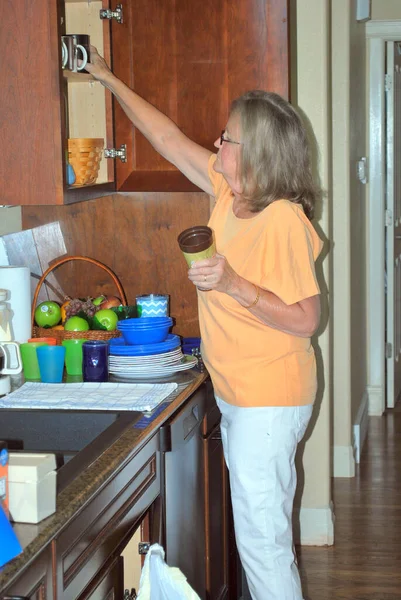 Зрелая Женщина Старшеклассница Работает Кухне Дома — стоковое фото