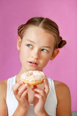 girl holding an appetizing glazed donut in her hands clipart