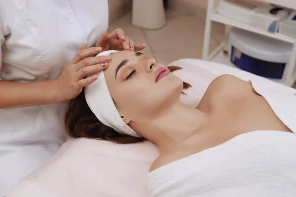 Face Massage of a Young Woman Getting Spa Treatment.