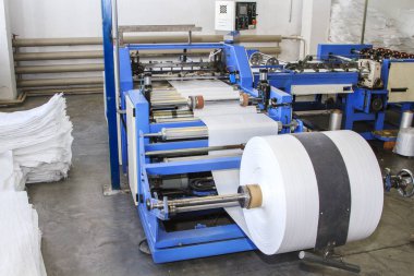 Big polymeric tape roll unreel for a printing press clipart