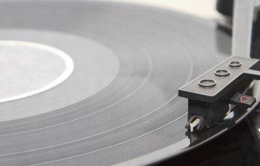 turntable with stylus running along a vinyl record clipart