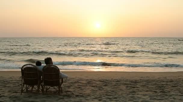 Casal Amoroso Desfrutando Pôr Sol Sentado Poltronas Perto Costa Oceânica — Vídeo de Stock