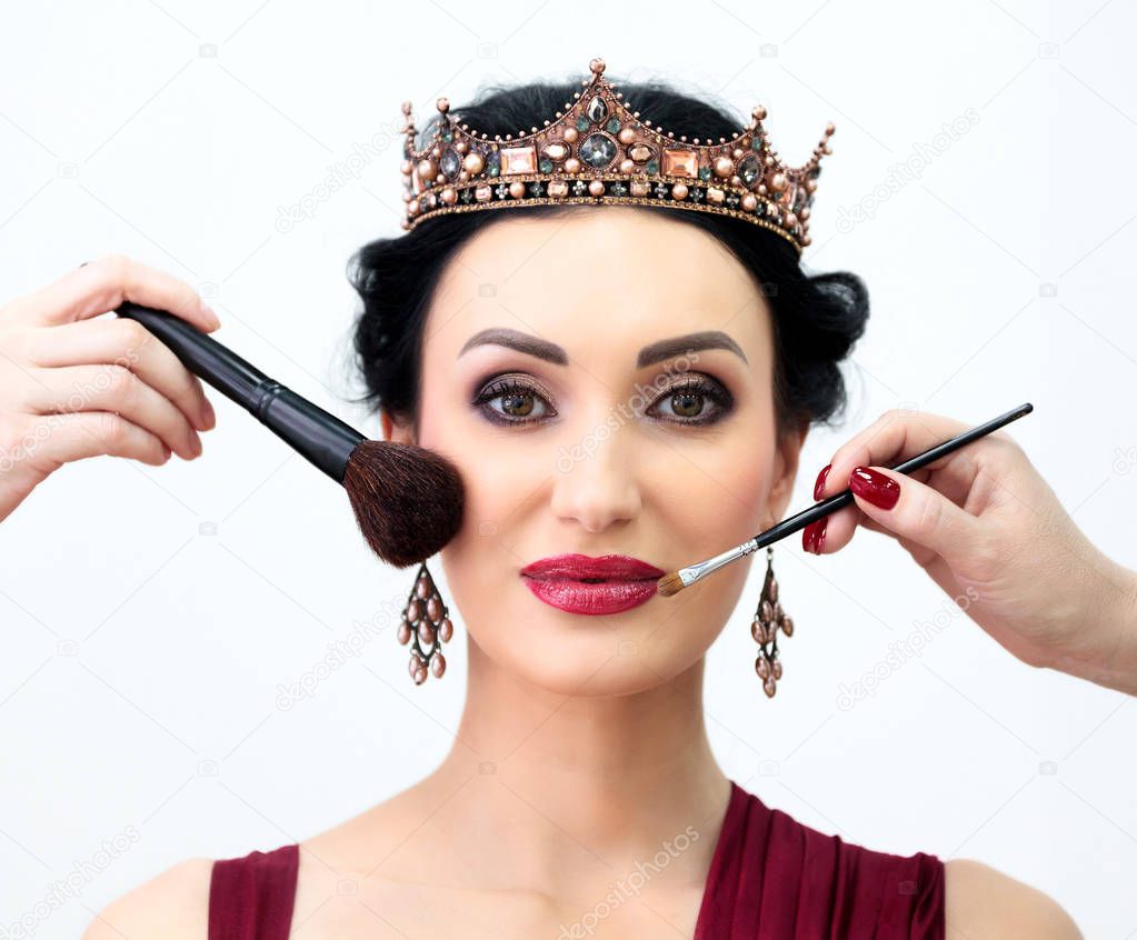 Closeup shot of beauty queen model in makeup process