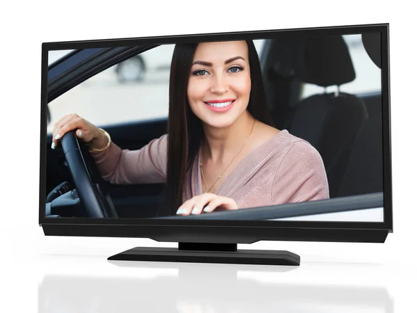 Happy owner of a new car on a screen of black LED monitor. Smiling young pretty woman sitting in her automobile