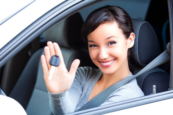 Genç kadını sürücüsü yeni arabada araba anahtarları tutun mutlu — Stok fotoğraf