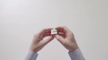 İşadamı çözme bulmaca oyuncak eller. Bulmaca küp, puzzle oyunu, en çok satan oyuncak. Adamın elinde bir gömlek gülümsemek. Bölüm 01.